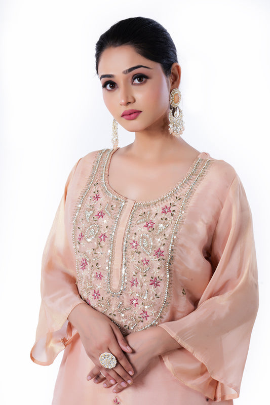 Straight Kurta Set with Banarasi Dupatta is made from luxurious Tissue and Zardozi Embroidery in Peach Colour